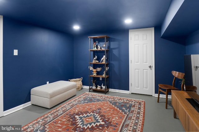 sitting room featuring concrete flooring