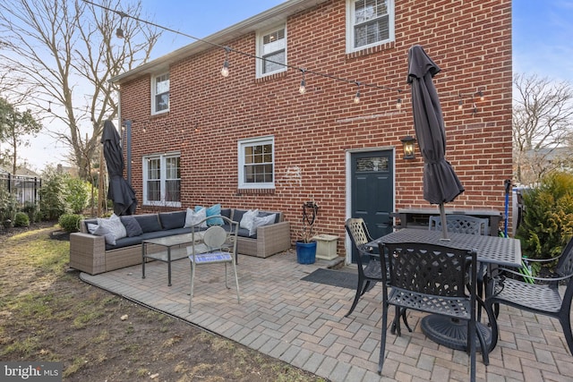 back of house featuring an outdoor living space and a patio area