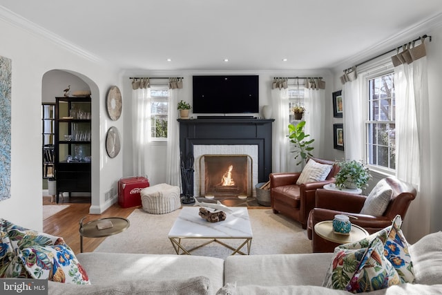 living room with crown molding and hardwood / wood-style floors