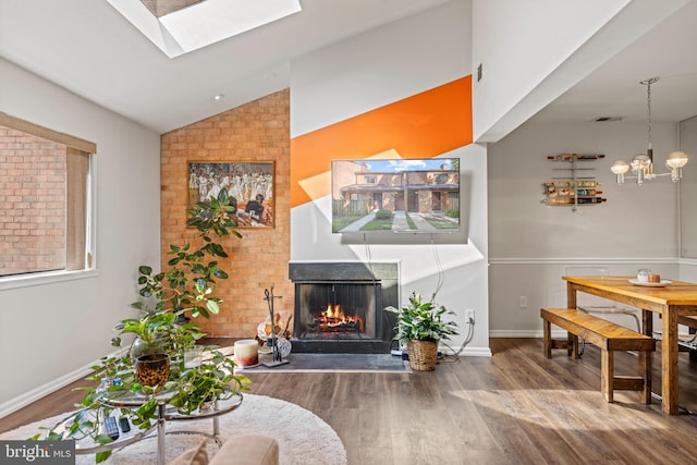 living room featuring wood-type flooring and lofted ceiling with skylight