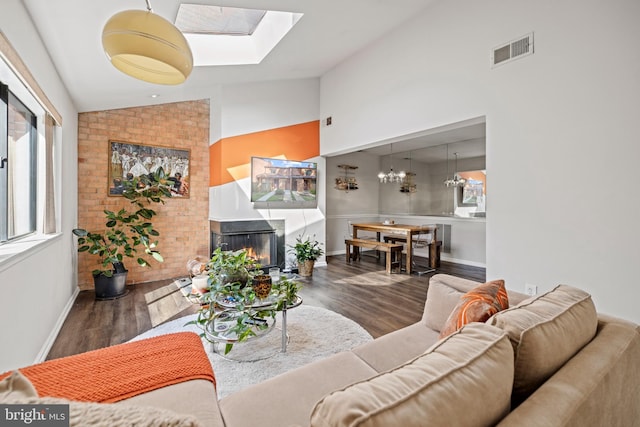 living room featuring dark wood-type flooring and lofted ceiling with skylight