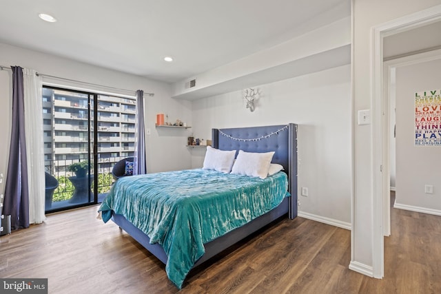 bedroom featuring dark wood-type flooring and access to outside