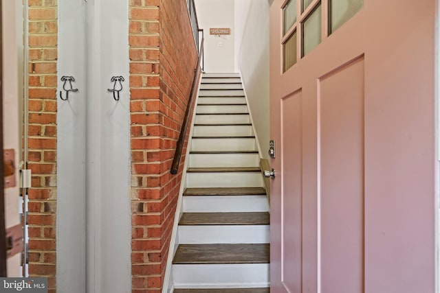 staircase with brick wall