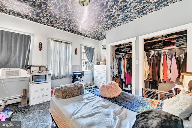 bedroom featuring cooling unit and a baseboard radiator