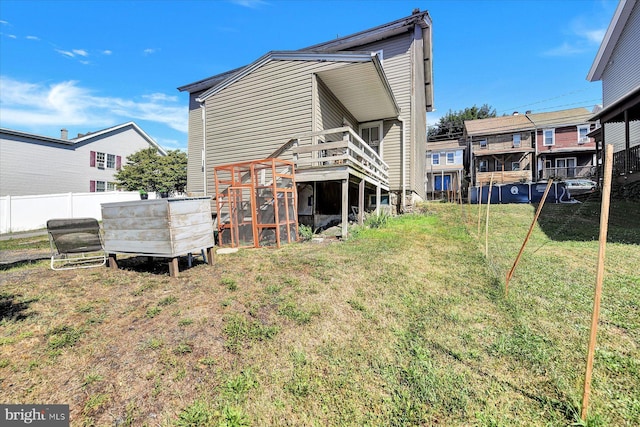 back of property featuring a yard