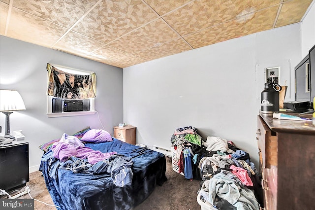 bedroom with a baseboard heating unit and cooling unit