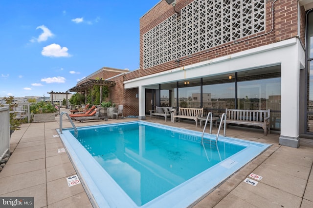 view of swimming pool featuring a patio area and a pergola