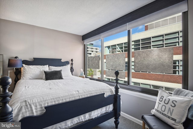 carpeted bedroom with a textured ceiling