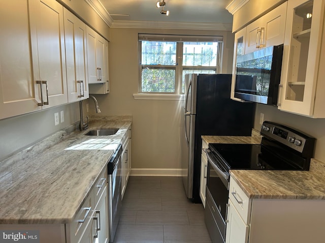 kitchen featuring stainless steel appliances, white cabinetry, and ornamental molding