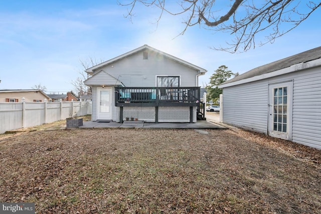 rear view of house with a wooden deck