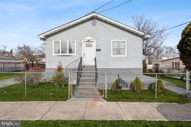 bungalow-style house with a front lawn