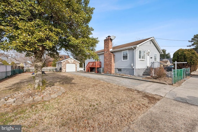 view of front of house featuring a garage and an outdoor structure