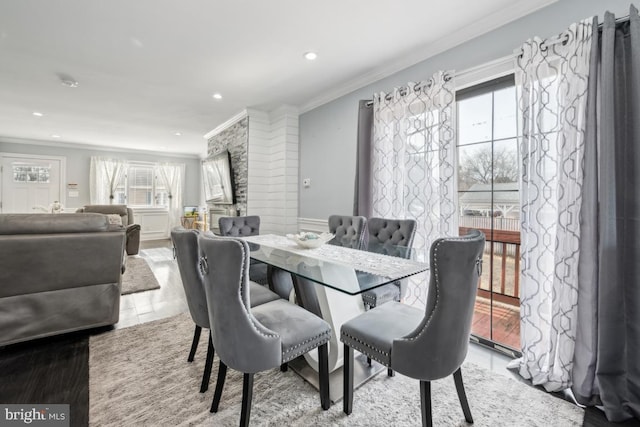 dining area with crown molding and plenty of natural light