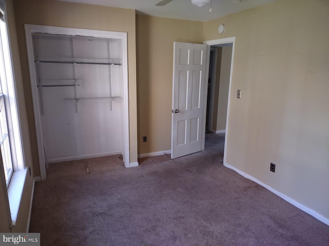 unfurnished bedroom with ceiling fan, carpet floors, and a closet