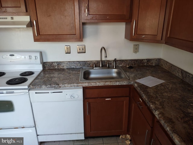 kitchen featuring sink, white appliances, and light tile patterned flooring