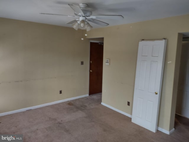 spare room with light colored carpet and ceiling fan