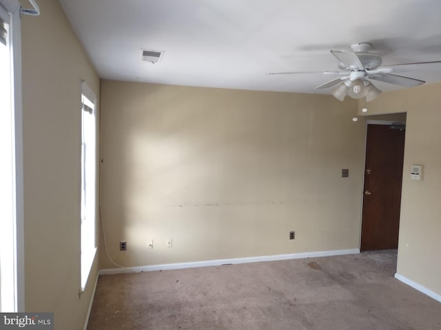 spare room featuring ceiling fan and light carpet