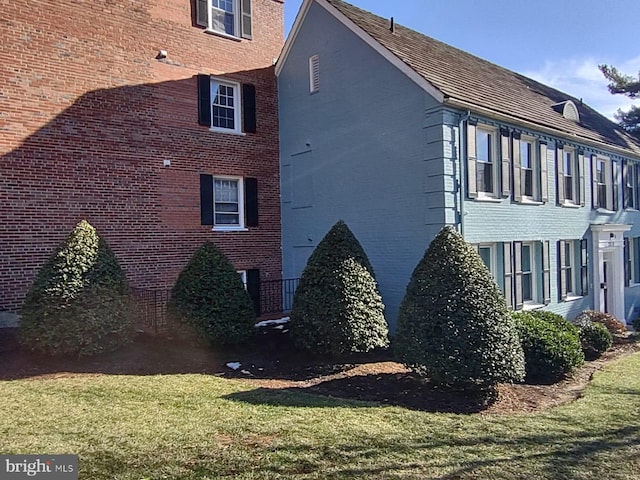 view of side of home featuring a lawn