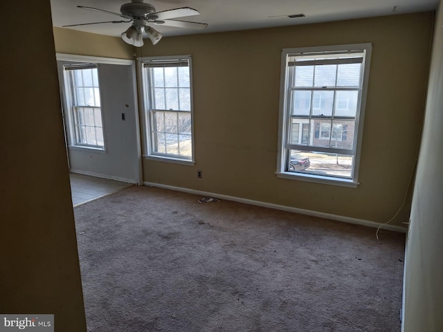 carpeted spare room with ceiling fan