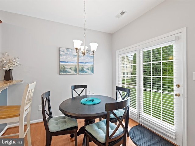 dining space featuring a notable chandelier and light hardwood / wood-style flooring