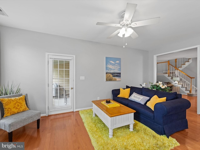 living room featuring ceiling fan and light wood-type flooring