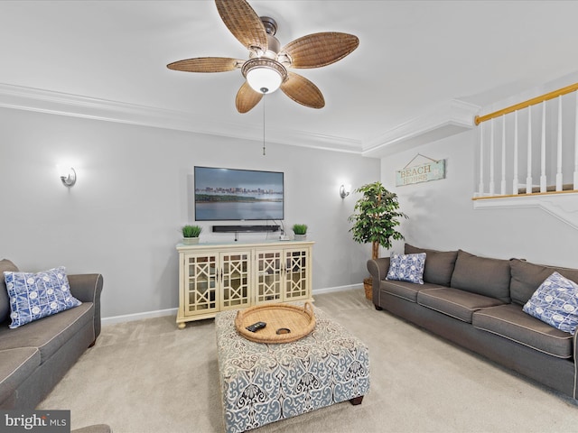 living room featuring ornamental molding, light colored carpet, and ceiling fan