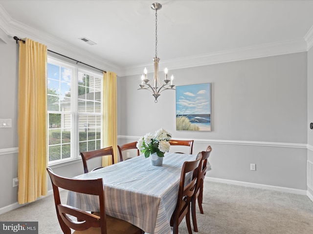 dining room featuring crown molding, a wealth of natural light, light colored carpet, and a chandelier