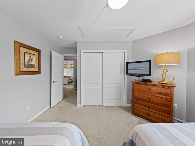 bedroom with light carpet and a closet