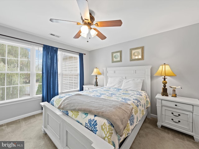 bedroom with ceiling fan and light colored carpet