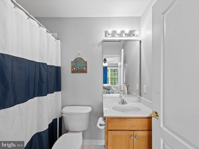 bathroom featuring vanity, tile patterned flooring, and toilet