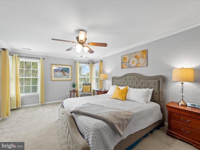 carpeted bedroom with ceiling fan, ornamental molding, and multiple windows