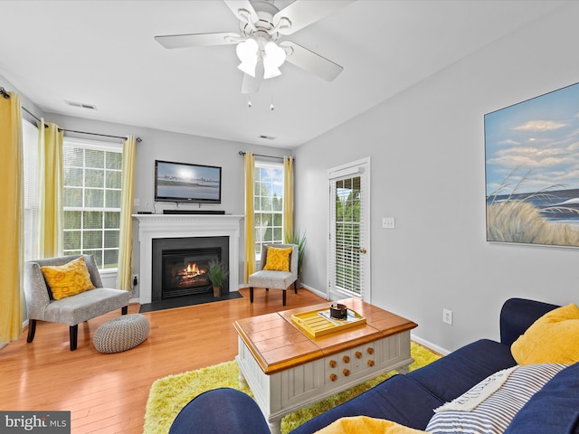 living room with hardwood / wood-style floors, plenty of natural light, and ceiling fan