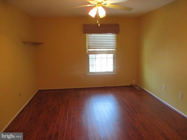 spare room featuring ceiling fan and dark hardwood / wood-style flooring