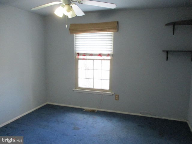 carpeted spare room featuring ceiling fan