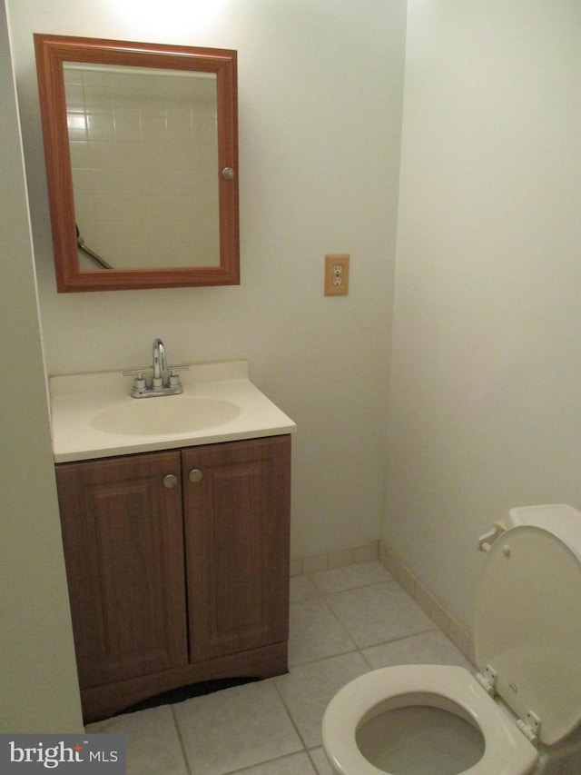 bathroom featuring vanity, tile patterned floors, and toilet