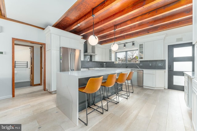 kitchen with white cabinetry, stainless steel appliances, and a center island