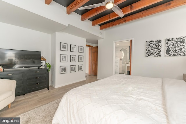 bedroom featuring beam ceiling, ensuite bath, and light wood-type flooring