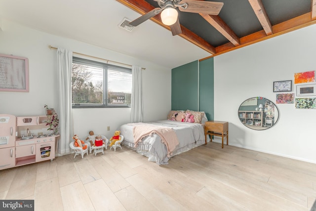 bedroom featuring beam ceiling, light hardwood / wood-style flooring, and ceiling fan