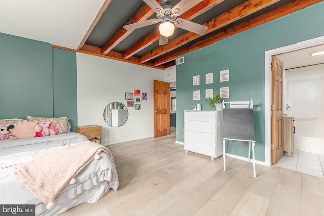 bedroom with beam ceiling and light hardwood / wood-style floors