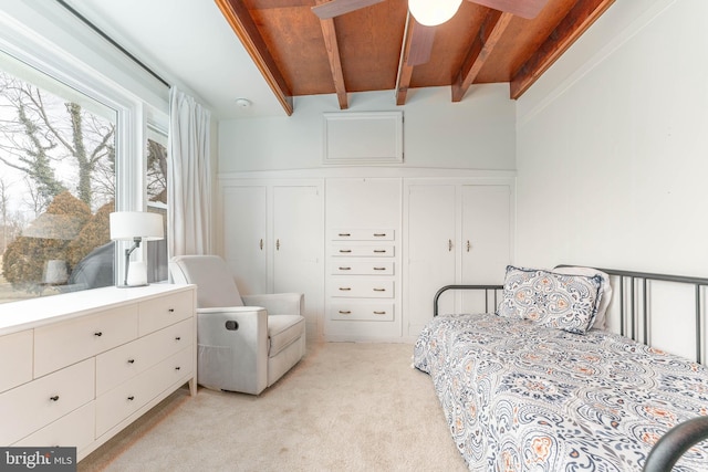 bedroom featuring beamed ceiling and light carpet