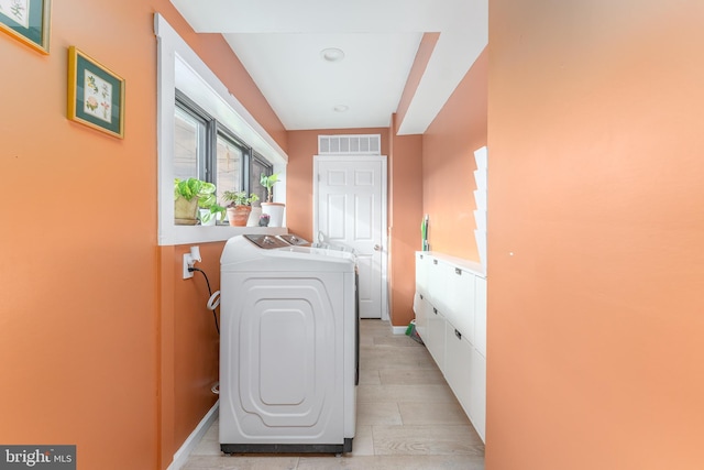 clothes washing area featuring separate washer and dryer