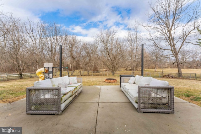 view of patio featuring a playground and an outdoor living space with a fire pit