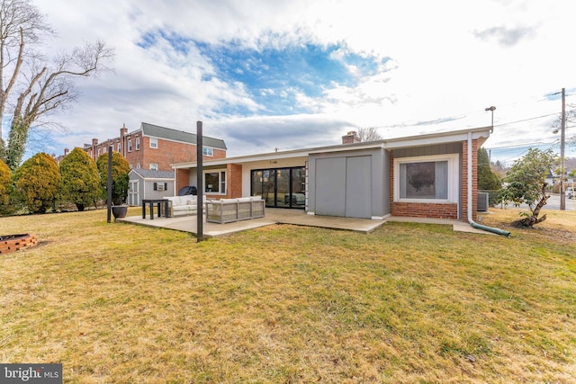 rear view of house featuring a patio, an outdoor hangout area, central AC unit, and a lawn