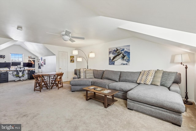 carpeted living room with ceiling fan and lofted ceiling