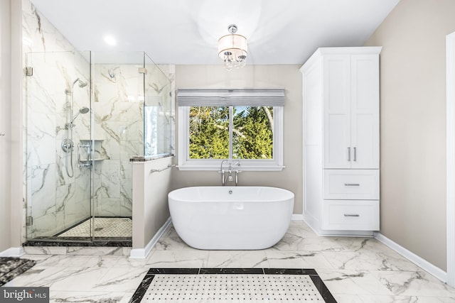 bathroom featuring a chandelier and independent shower and bath