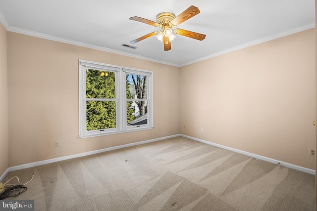 empty room featuring ceiling fan, ornamental molding, and carpet