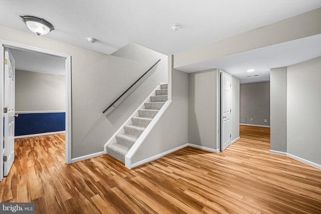 stairway with hardwood / wood-style flooring