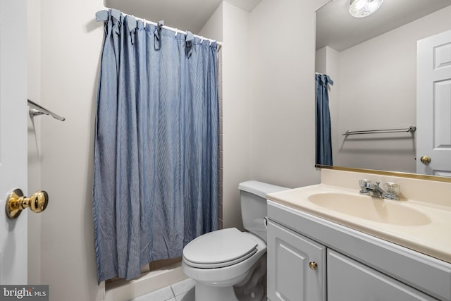 bathroom with a shower with curtain, tile patterned floors, vanity, and toilet