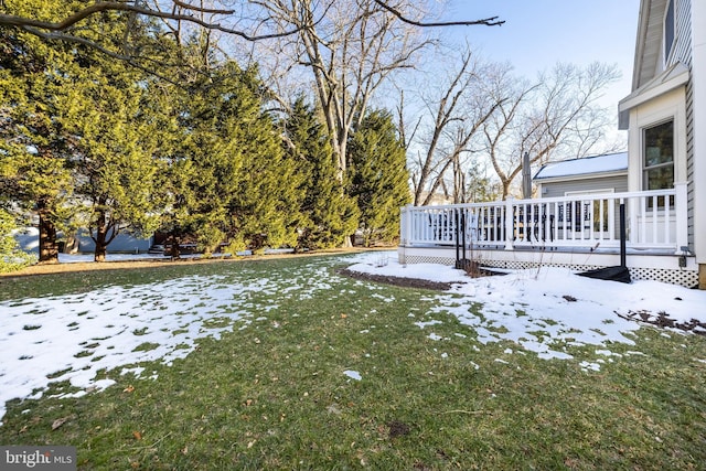 snowy yard featuring a deck