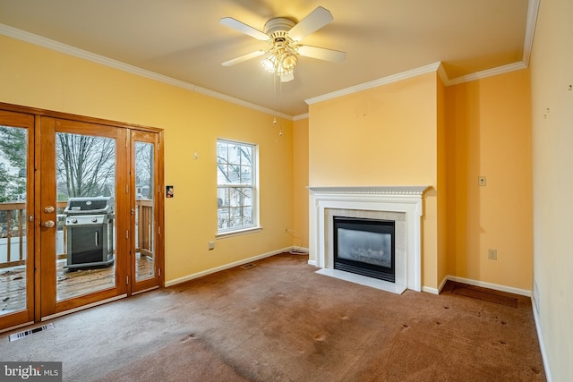 unfurnished living room with ornamental molding, carpet, and ceiling fan